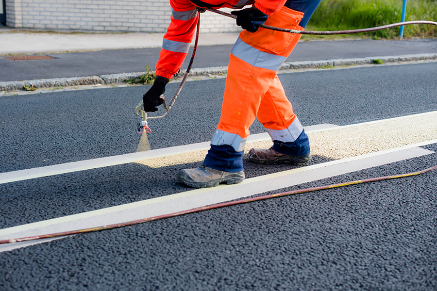Paint lines being sprayed on to a road