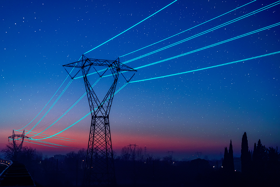 Outline of power grid lines against a sun set