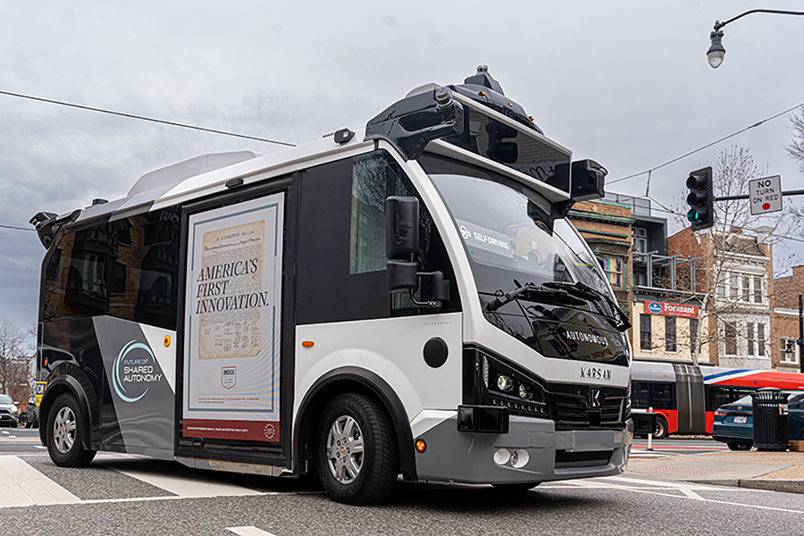 AV bus driving on a street in Washington DC.
