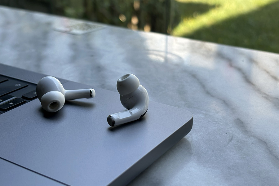 Wireless earbuds sitting on a computer