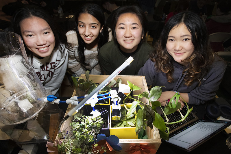 Four female students presenting plant project at Demo Day.